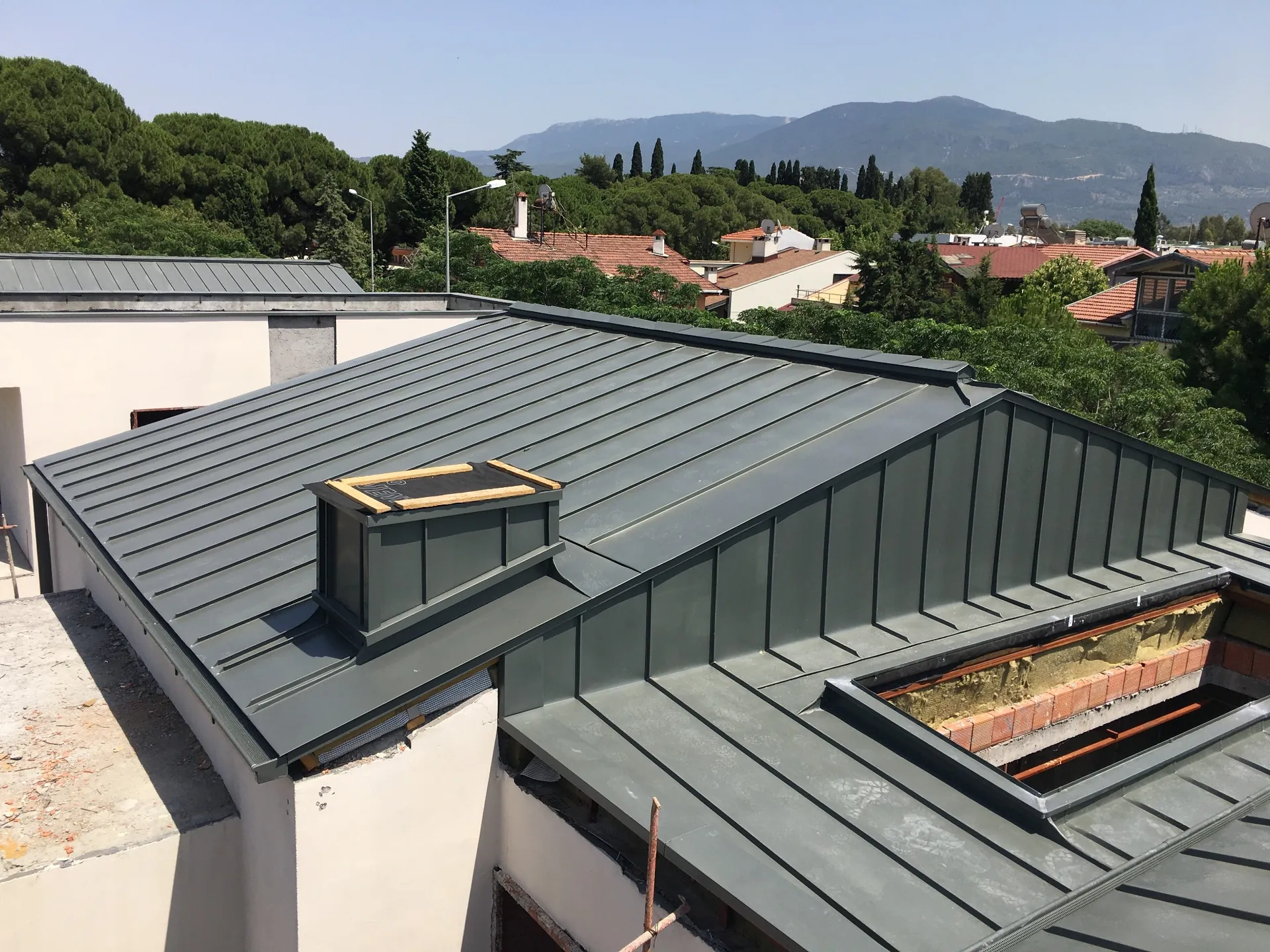 Completed standing seam roof and chimney detail