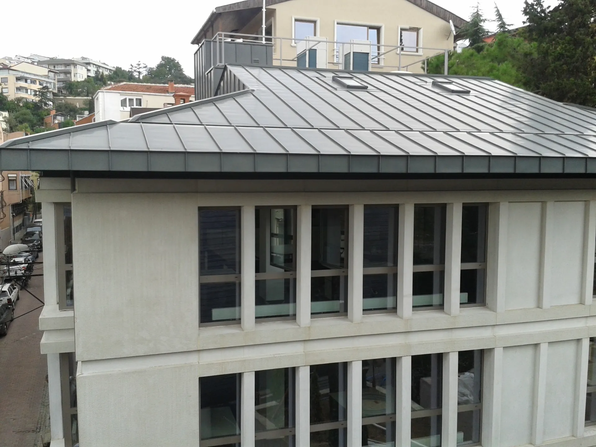 Standing seam metal roof system and rooflights on a stepped roof